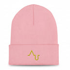 Pink beanie with a yellow logo on a black background