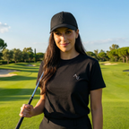 Woman holding a golf club on a golf course with trees and sky in the background