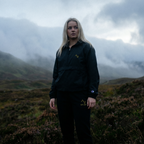 Person standing in a misty mountain landscape
