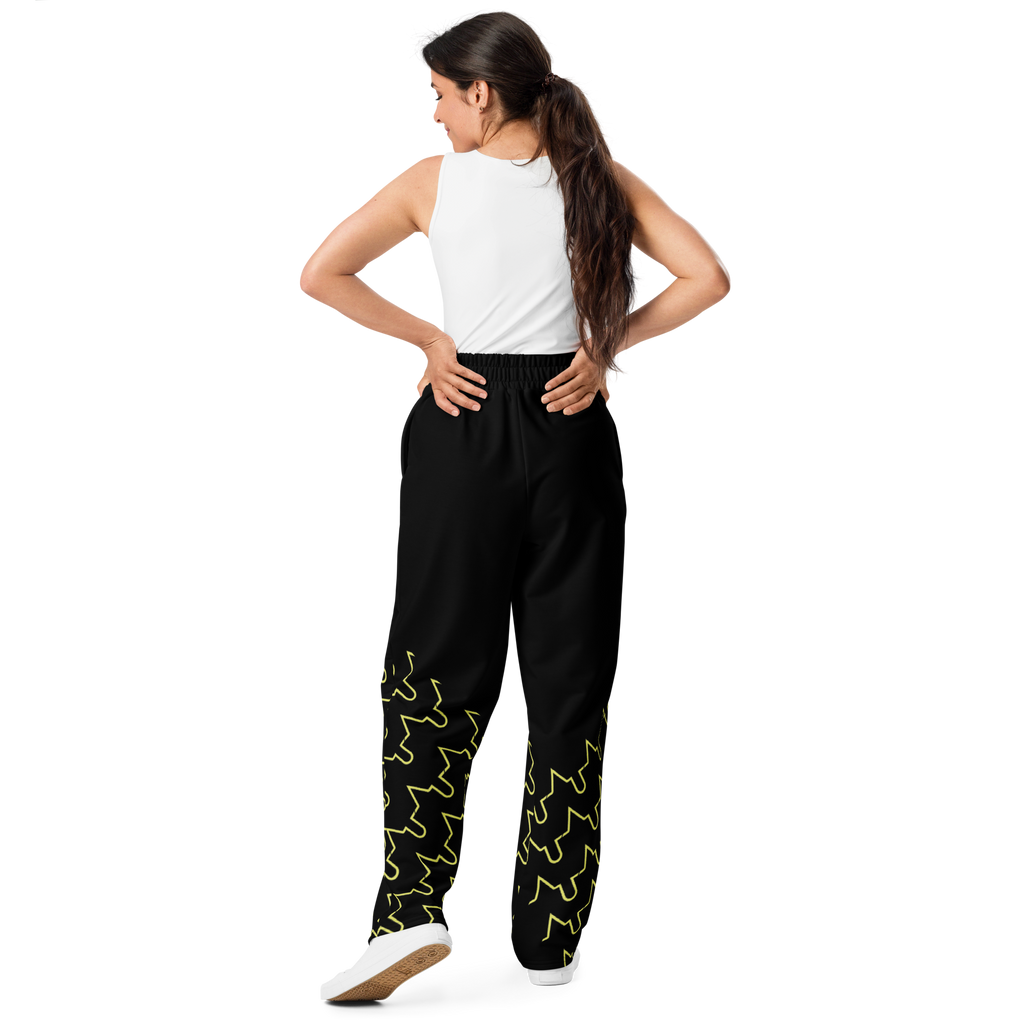 Woman wearing black pants with green patterns on a white background