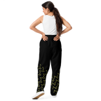 Woman wearing black pants with green patterns on a white background