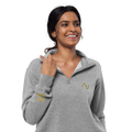 Woman wearing a gray pullover with a logo on a white background