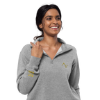Woman wearing a gray pullover with a logo on a white background